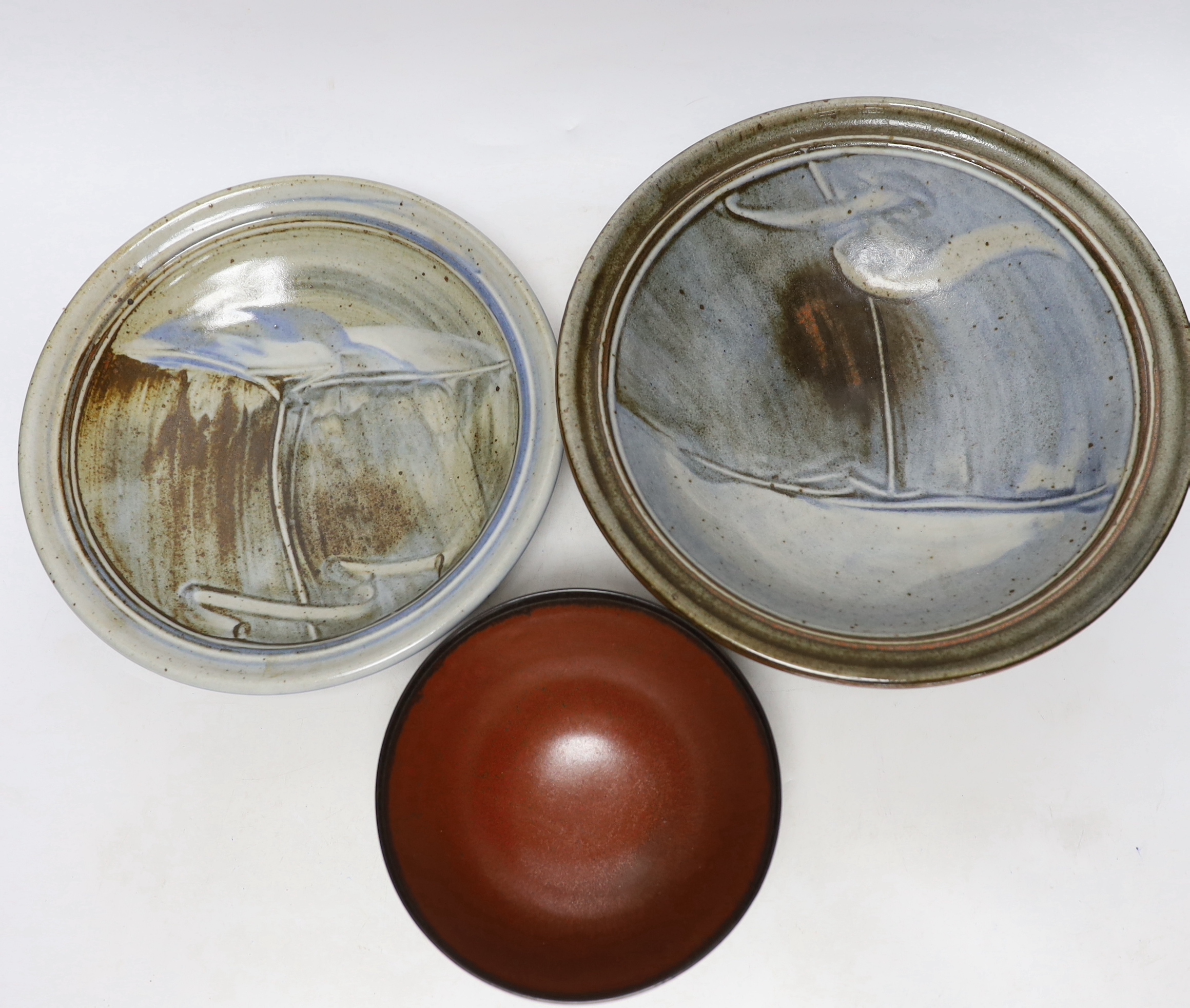 A bowl by Suleyman Saba, Australia and two shallow pottery bowls, largest diameter 28cm